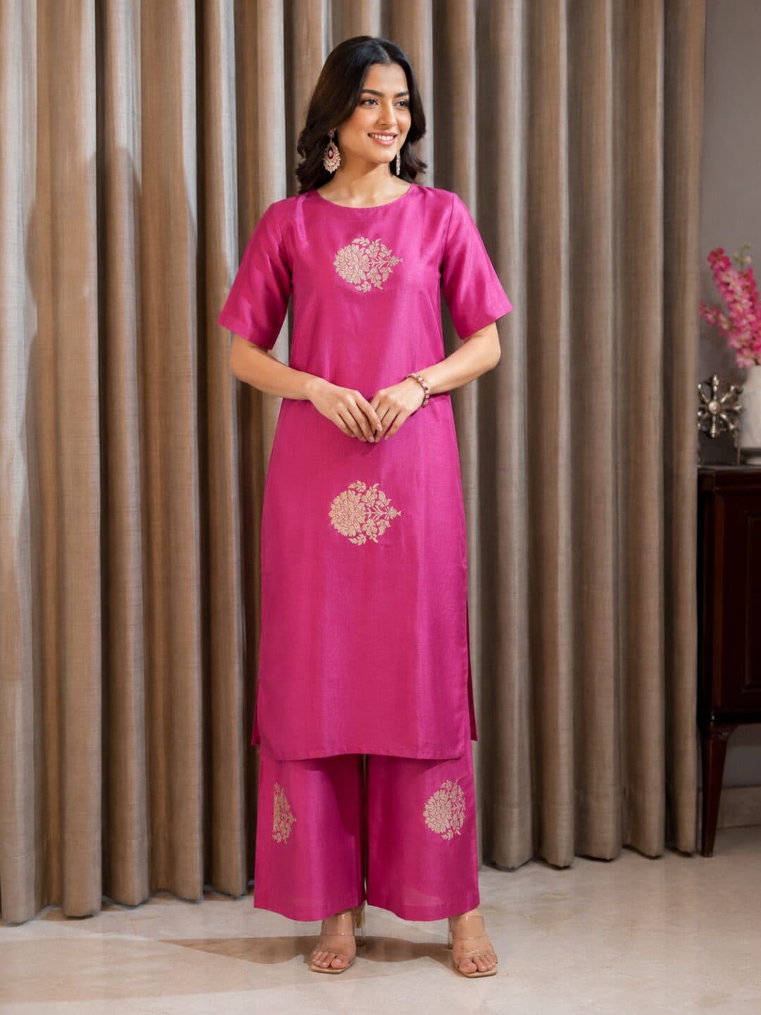 Magenta katan silk fabric with a gold kadwa booti floral medallion woven into the cloth